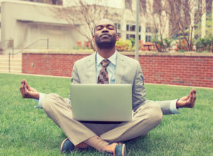 mindfulness tools - man meditating with laptop