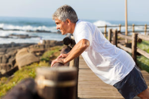 mens health fit senior man exercising at the beach in the morning