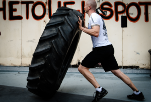 What Supplements Should I Take for CrossFit- Man lifting tire