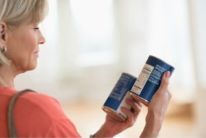 Women looking at ingredient label, Cancer-Causing Ingredients In Your Bathroom Cabinet