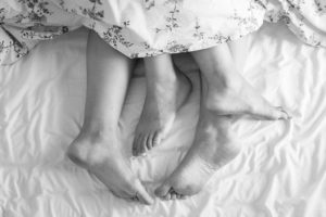 Supplements to Increase Sperm Count, two people in bed under covers showing feet.